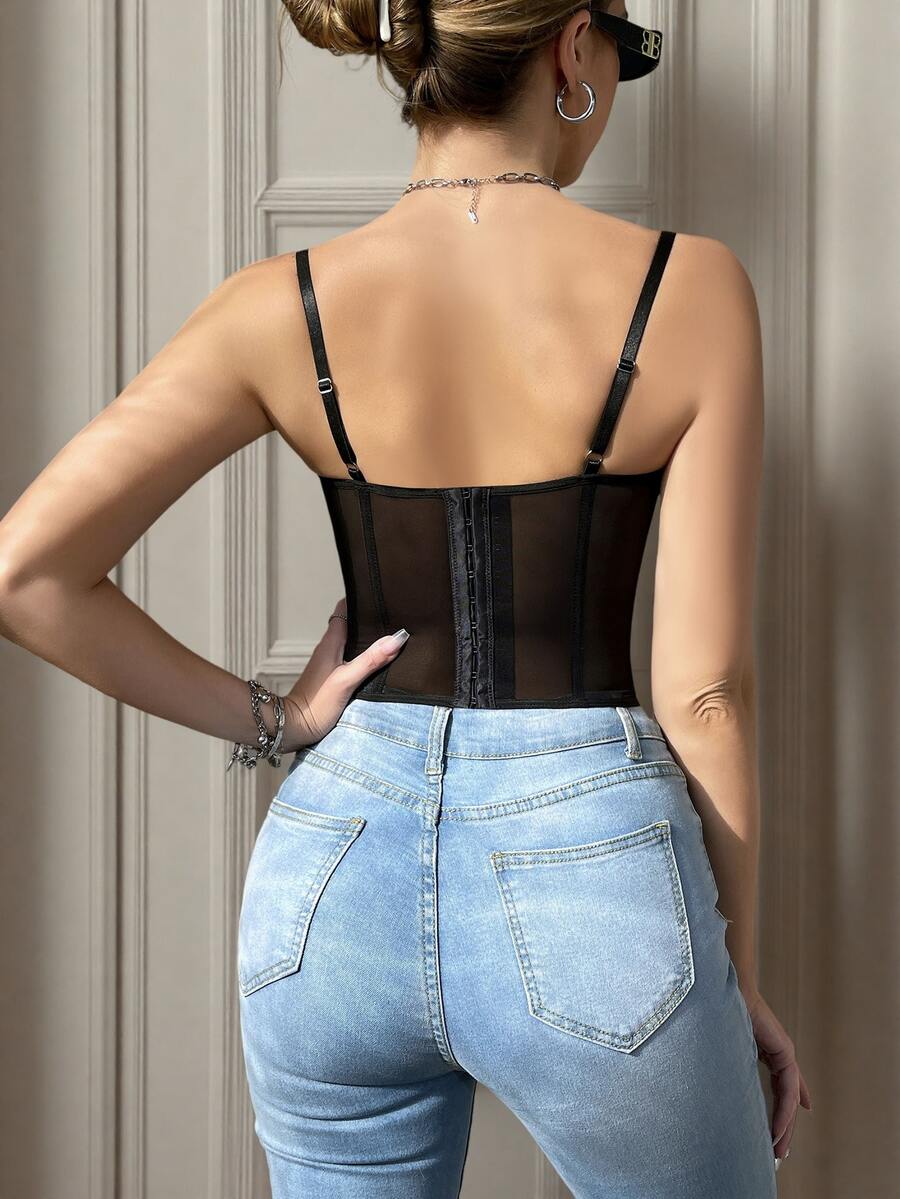 Black seamless lace camisole crop top featuring delicate contrast lace details and thin spaghetti straps.