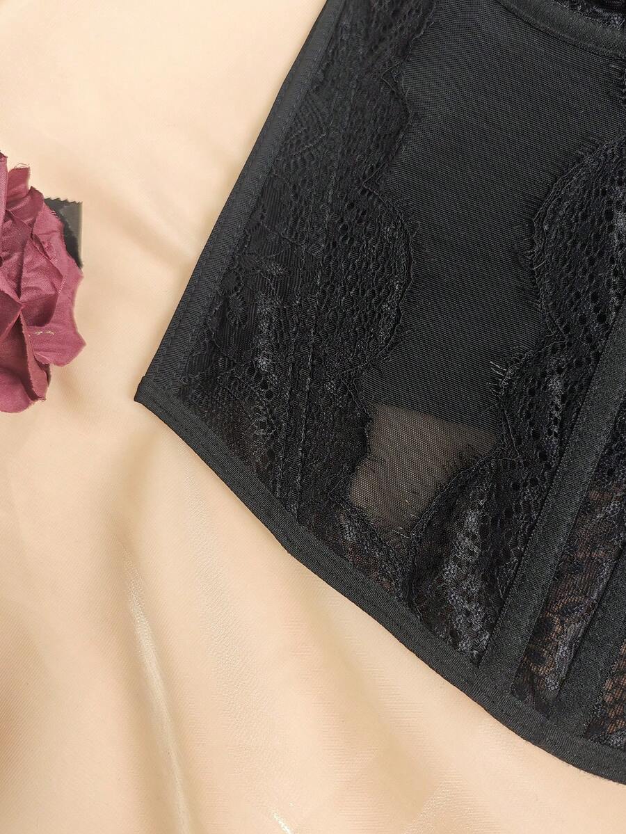 Black seamless lace camisole crop top featuring delicate contrast lace details and thin spaghetti straps.