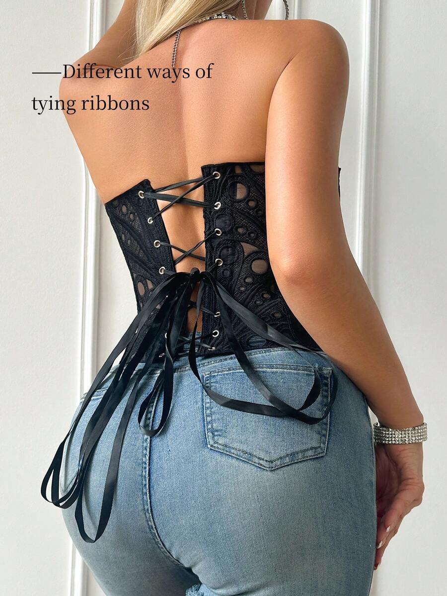Black lace shaping camisole top with a tie-back detail and grommet eyelet accents, designed for women with slight stretch and ultra-light support.