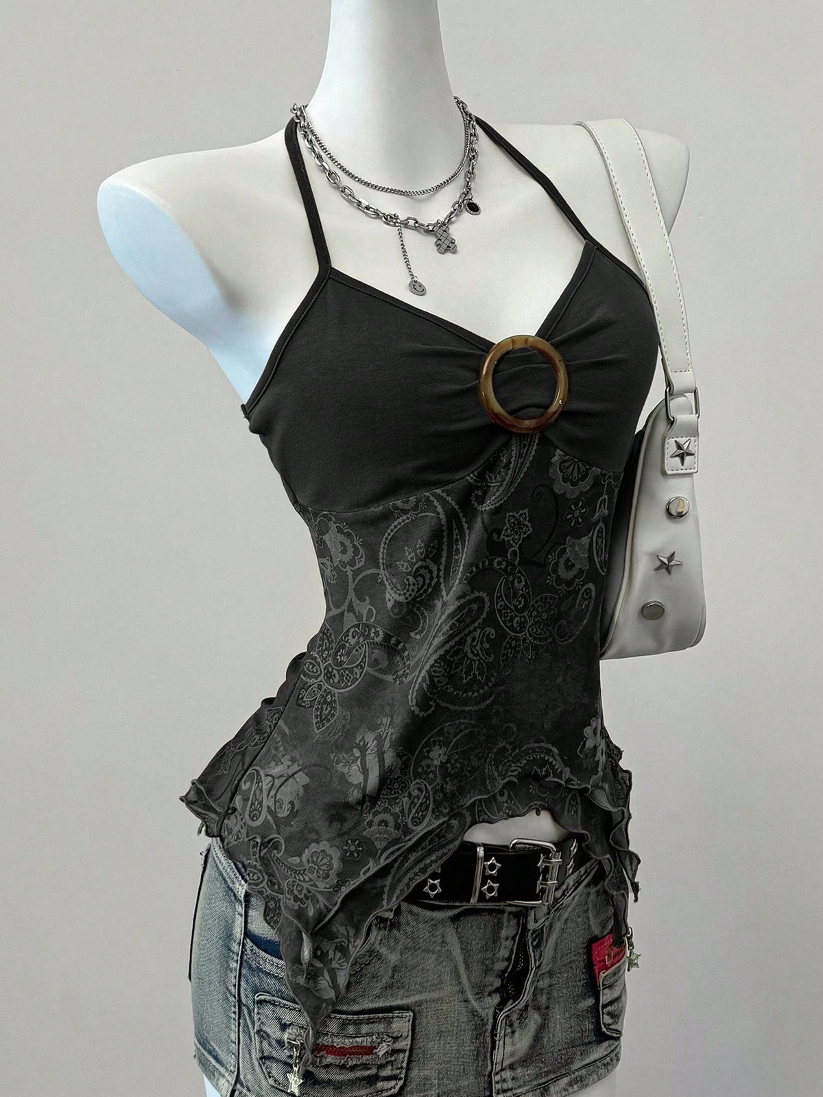 Women's backless halter cami top featuring a paisley print, sleeveless design, and an asymmetrical hem in knitted fabric.