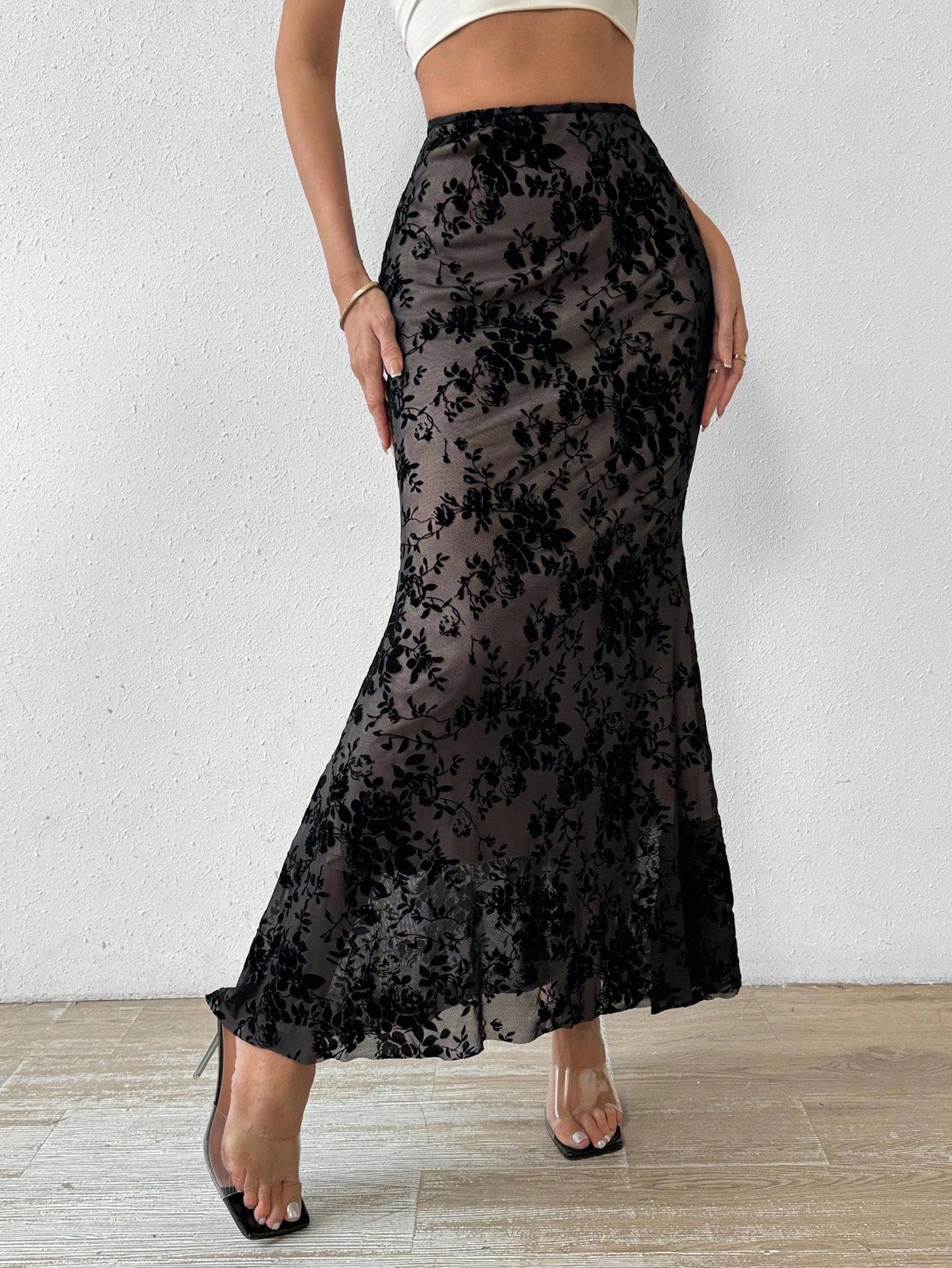 Women's black lace long mermaid skirt featuring lettuce trim, ruffle hem, random print pattern, low waist, and zipper detail.