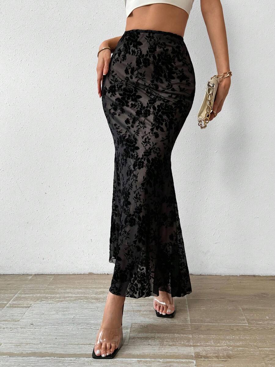 Women's black lace long mermaid skirt featuring lettuce trim, ruffle hem, random print pattern, low waist, and zipper detail.