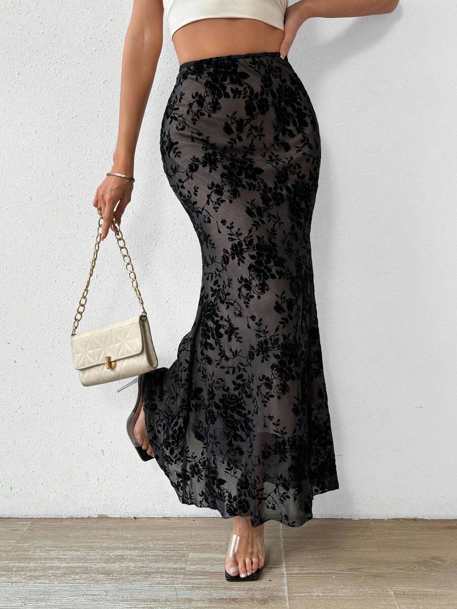 Women's black lace long mermaid skirt featuring lettuce trim, ruffle hem, random print pattern, low waist, and zipper detail.