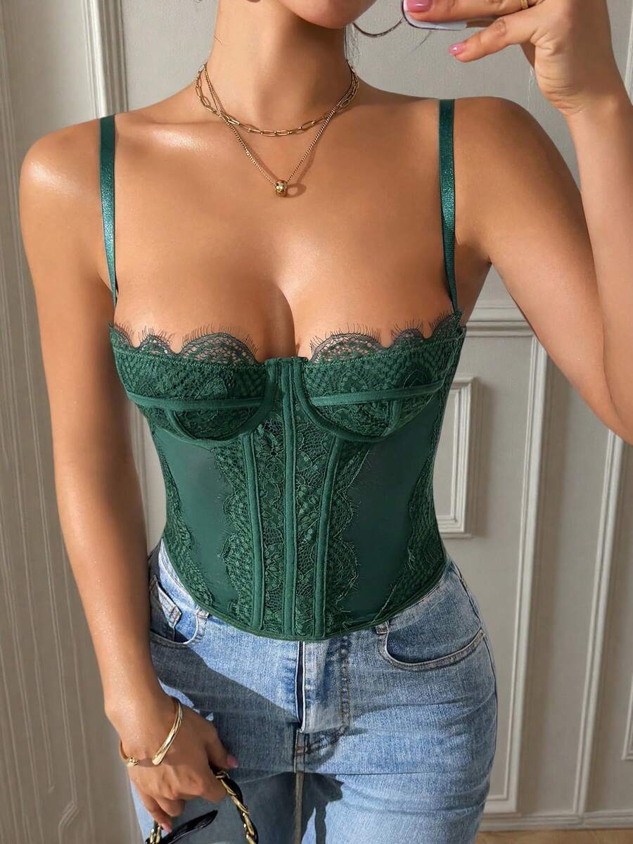 Front view of a black seamless lace camisole crop top featuring delicate spaghetti straps and intricate contrast lace detailing.