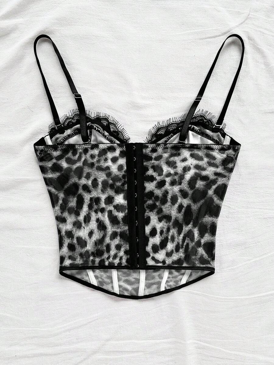 Women's lace bustier camisole top with spaghetti straps, contrast lace, lace-up detail, and an asymmetrical hem in a slim fit design.