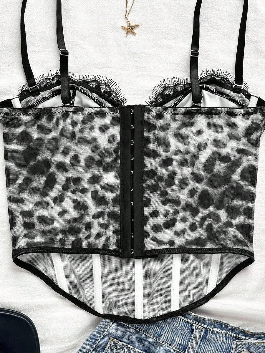 Women's lace bustier camisole top with spaghetti straps, contrast lace, lace-up detail, and an asymmetrical hem in a slim fit design.