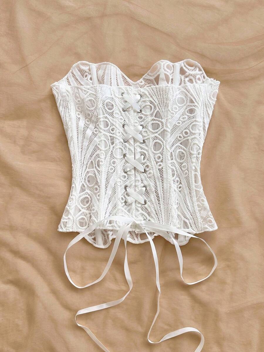 Women’s strapless corset bustier top with lace-up detail, asymmetrical embroidery, semi-sheer finish, and slim fit.