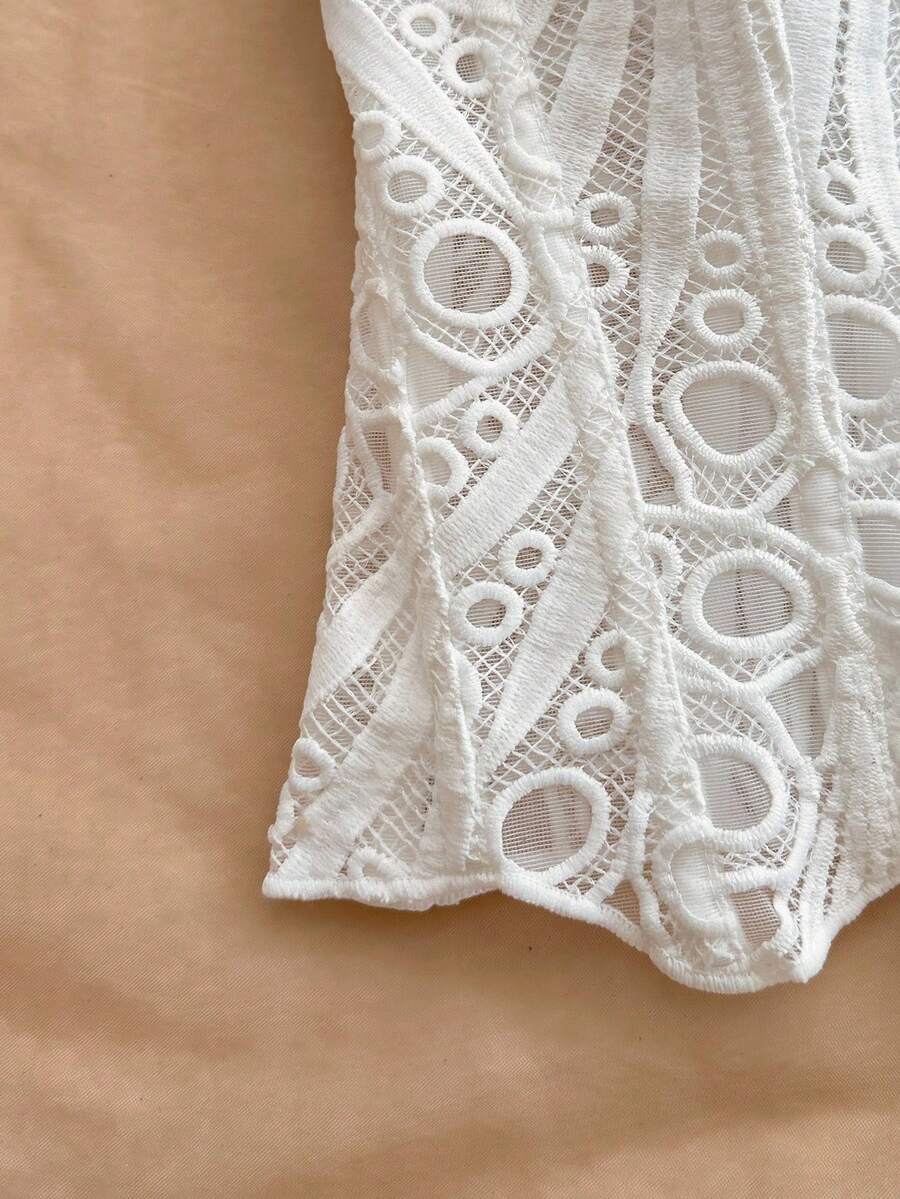 Women’s strapless corset bustier top with lace-up detail, asymmetrical embroidery, semi-sheer finish, and slim fit.