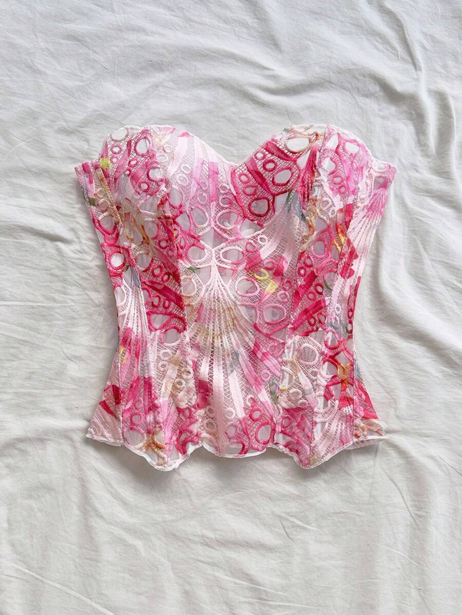 Strapless floral corset top with lace-up detail, asymmetrical hem, and slim fit for women in a boho vacation style.