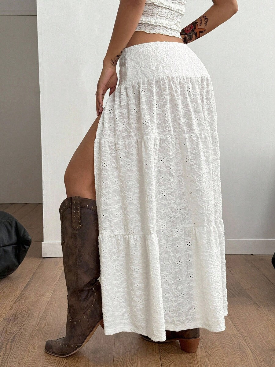 Women's black low waist split thigh long skirt featuring semi-sheer textured fabric and a flared skinny fit.