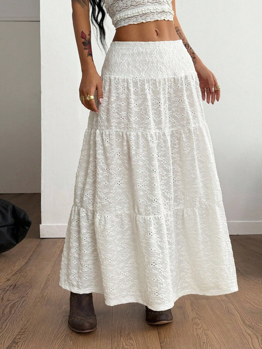 Women's black low waist split thigh long skirt featuring semi-sheer textured fabric and a flared skinny fit.