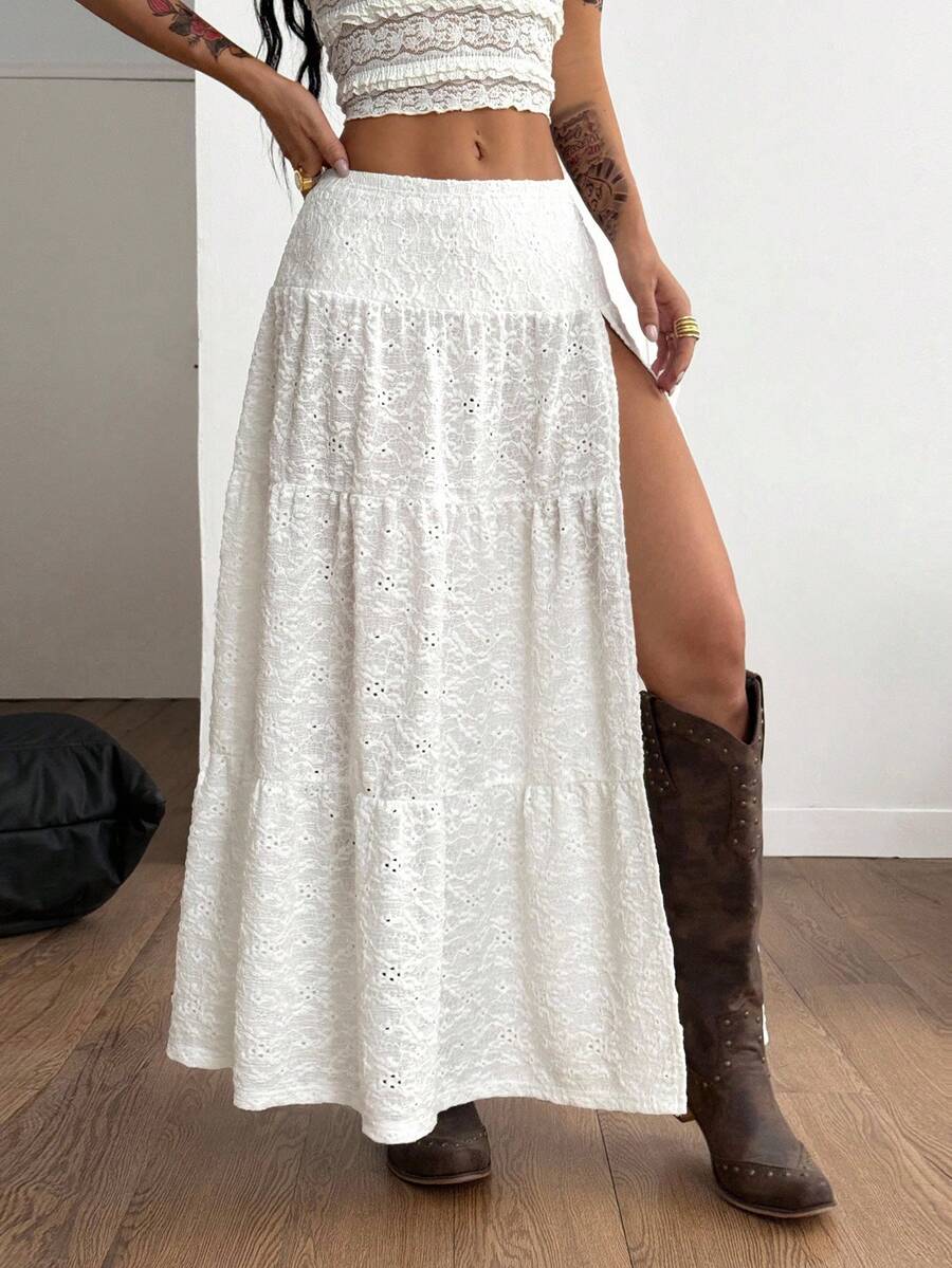 Women's black low waist split thigh long skirt featuring semi-sheer textured fabric and a flared skinny fit.