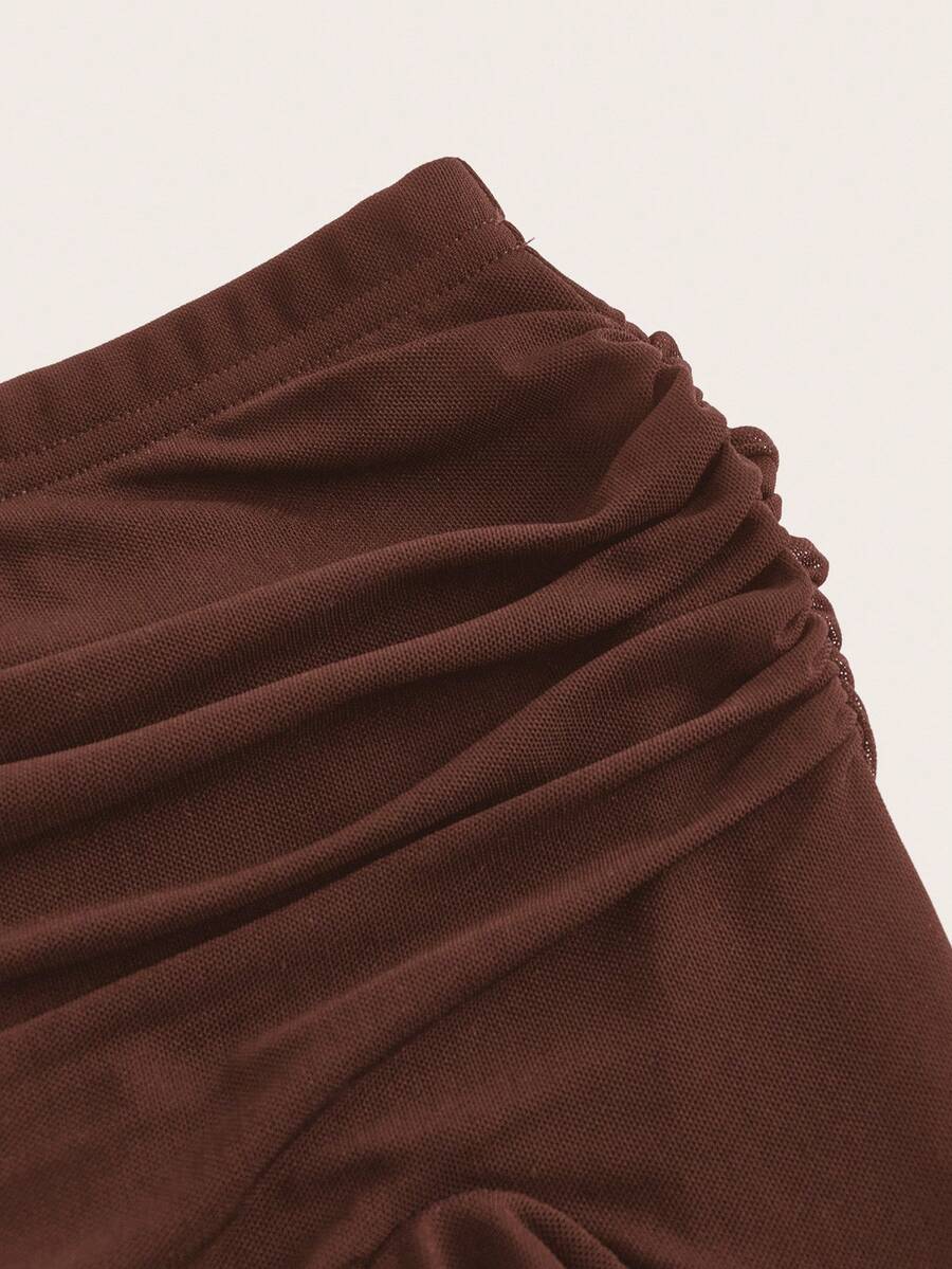 Women's black low rise asymmetrical midi skirt with ruched mesh fabric and layered ruffle hem