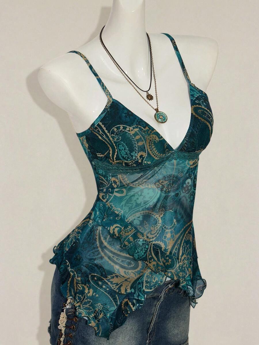 Women's burgundy floral graphic print mesh camisole top featuring an asymmetrical hem, backless cut, and spaghetti straps.