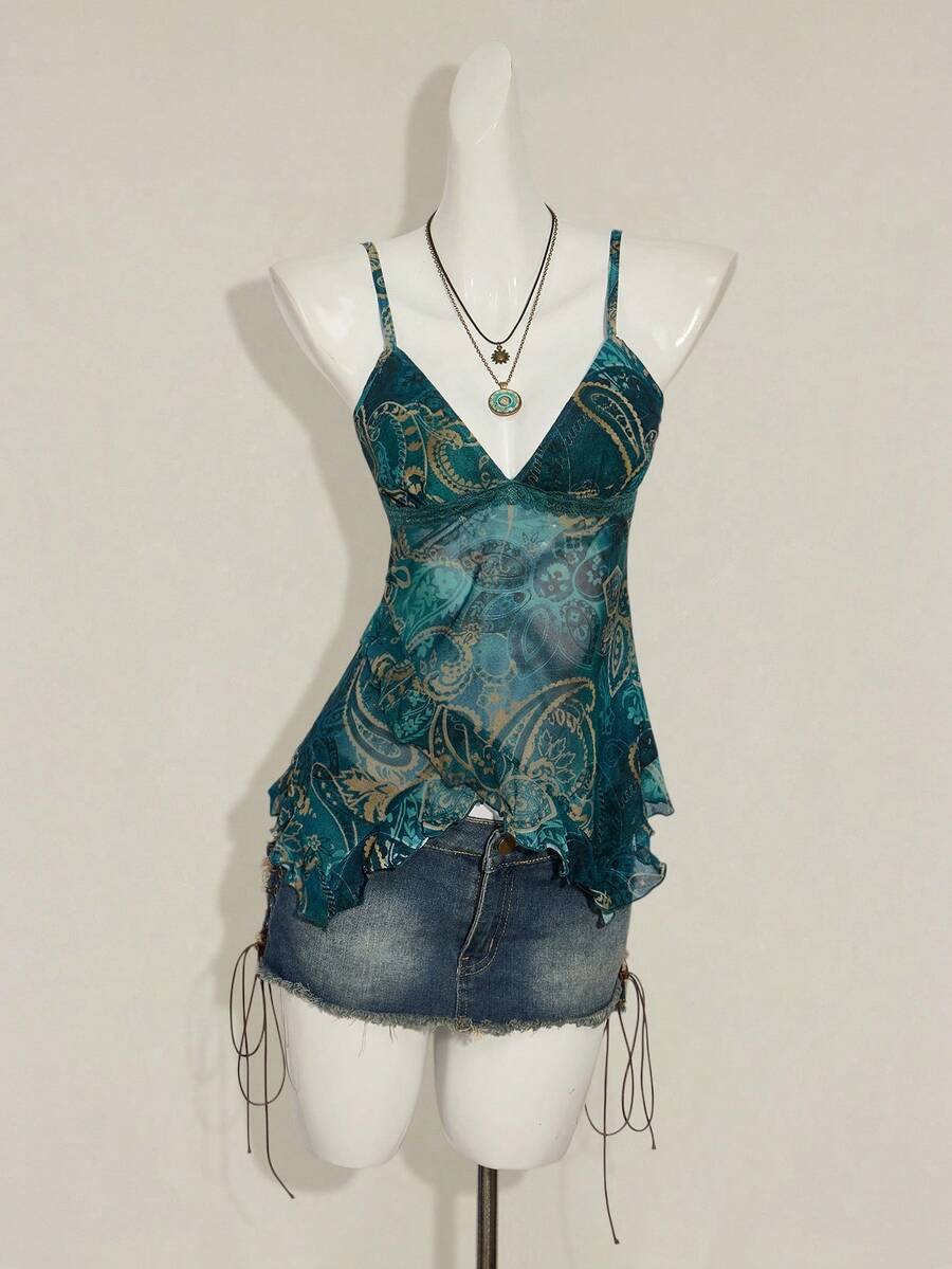 Women's burgundy floral graphic print mesh camisole top featuring an asymmetrical hem, backless cut, and spaghetti straps.