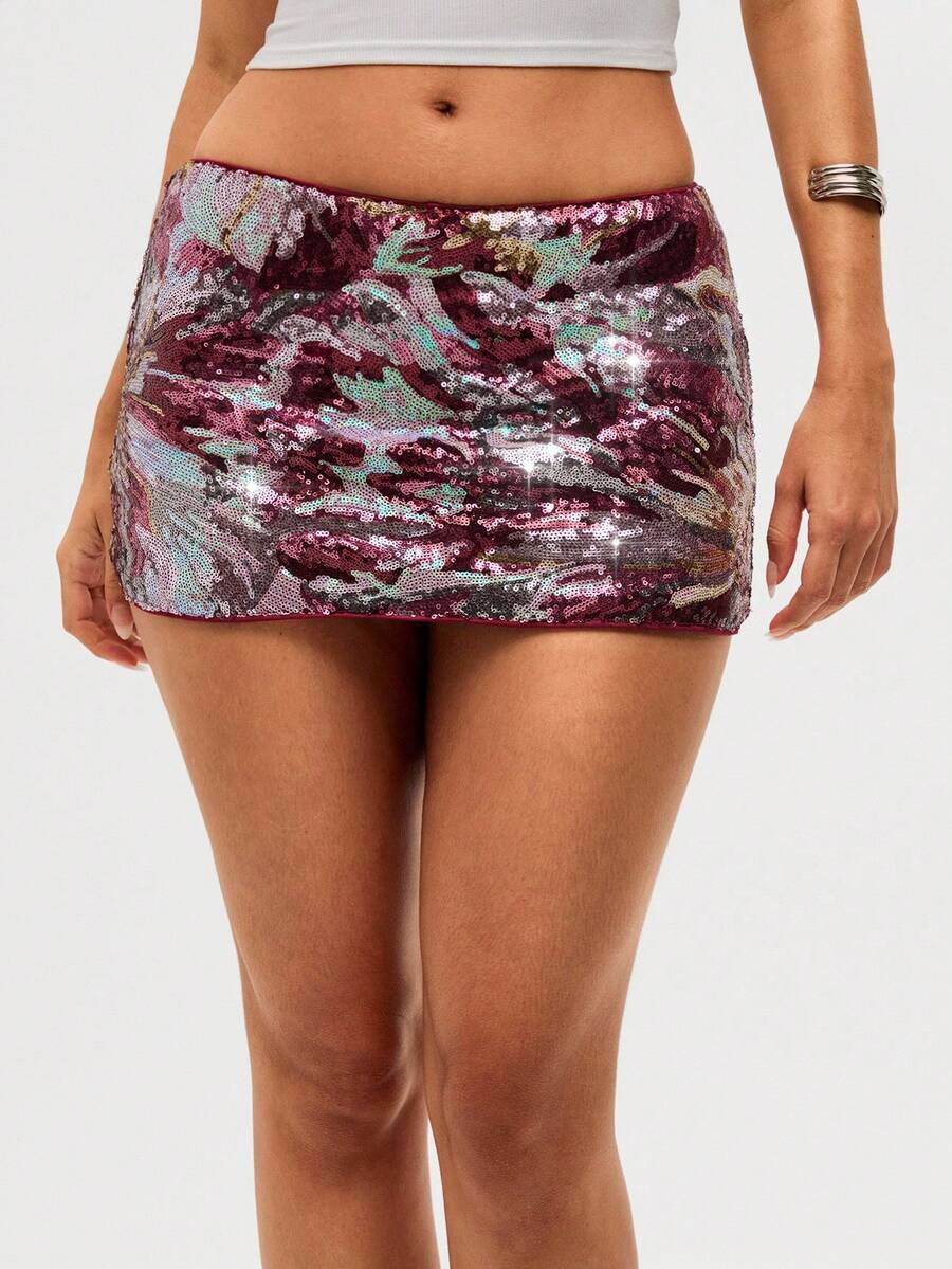 Burgundy shiny sequin bodycon mini skirt for women with low waist design, floral plant embroidery, and zipper detail.