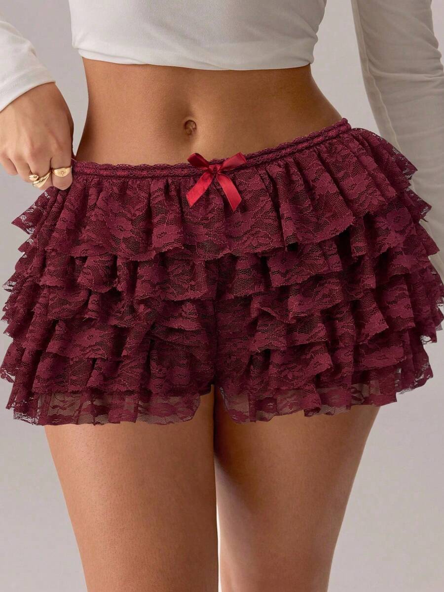 Apricot tiered lace ruffle hem low waist shorts for women featuring elastic waist and lined semi-sheer knit fabric.