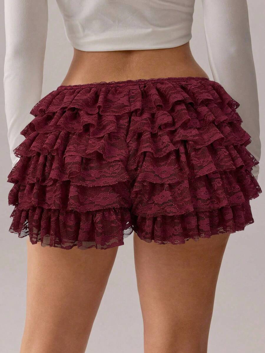 Apricot tiered lace ruffle hem low waist shorts for women featuring elastic waist and lined semi-sheer knit fabric.