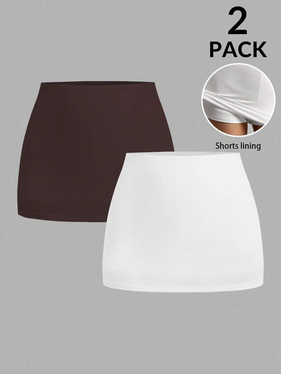 Women's black casual low rise bodycon mini skort with built-in shorts in knitted plain stretch fabric.