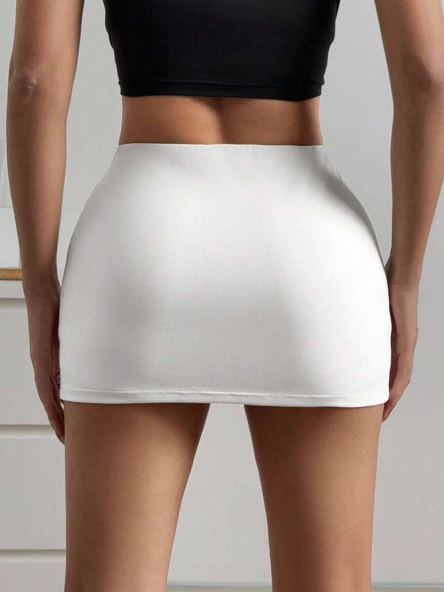 Women's black casual low rise bodycon mini skort with built-in shorts in knitted plain stretch fabric.