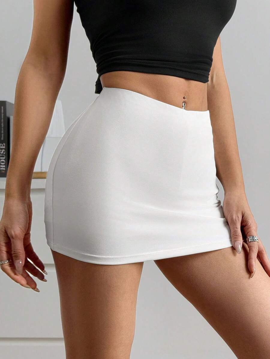 Women's black casual low rise bodycon mini skort with built-in shorts in knitted plain stretch fabric.