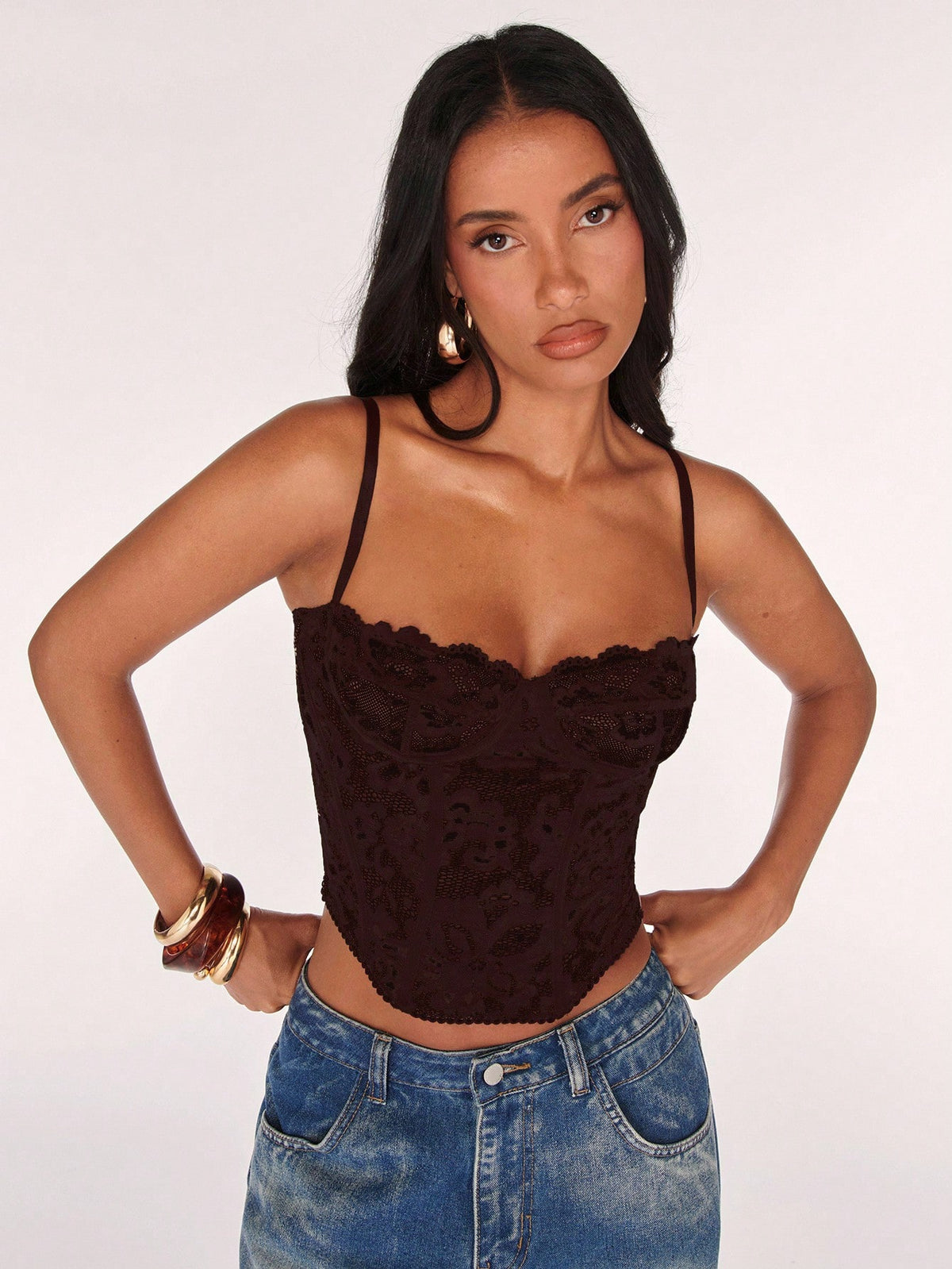 Women’s camisole top with cup detail, spaghetti straps, lined body, and slim fit design in knitted fabric with an asymmetrical hem.