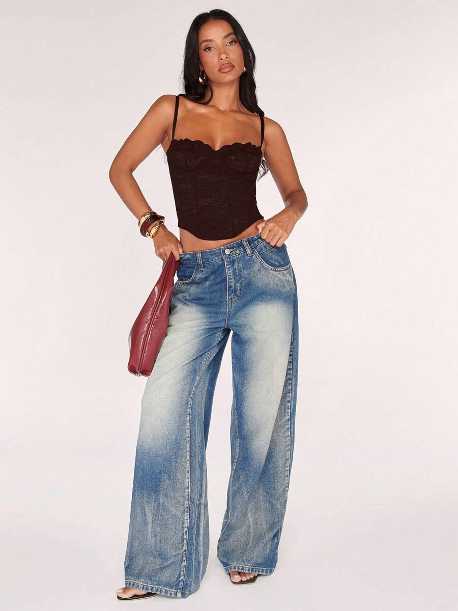 Black women’s lace cami top with spaghetti straps, contrast lace details, and an asymmetrical hem, styled as a slim-fit lined casual top.