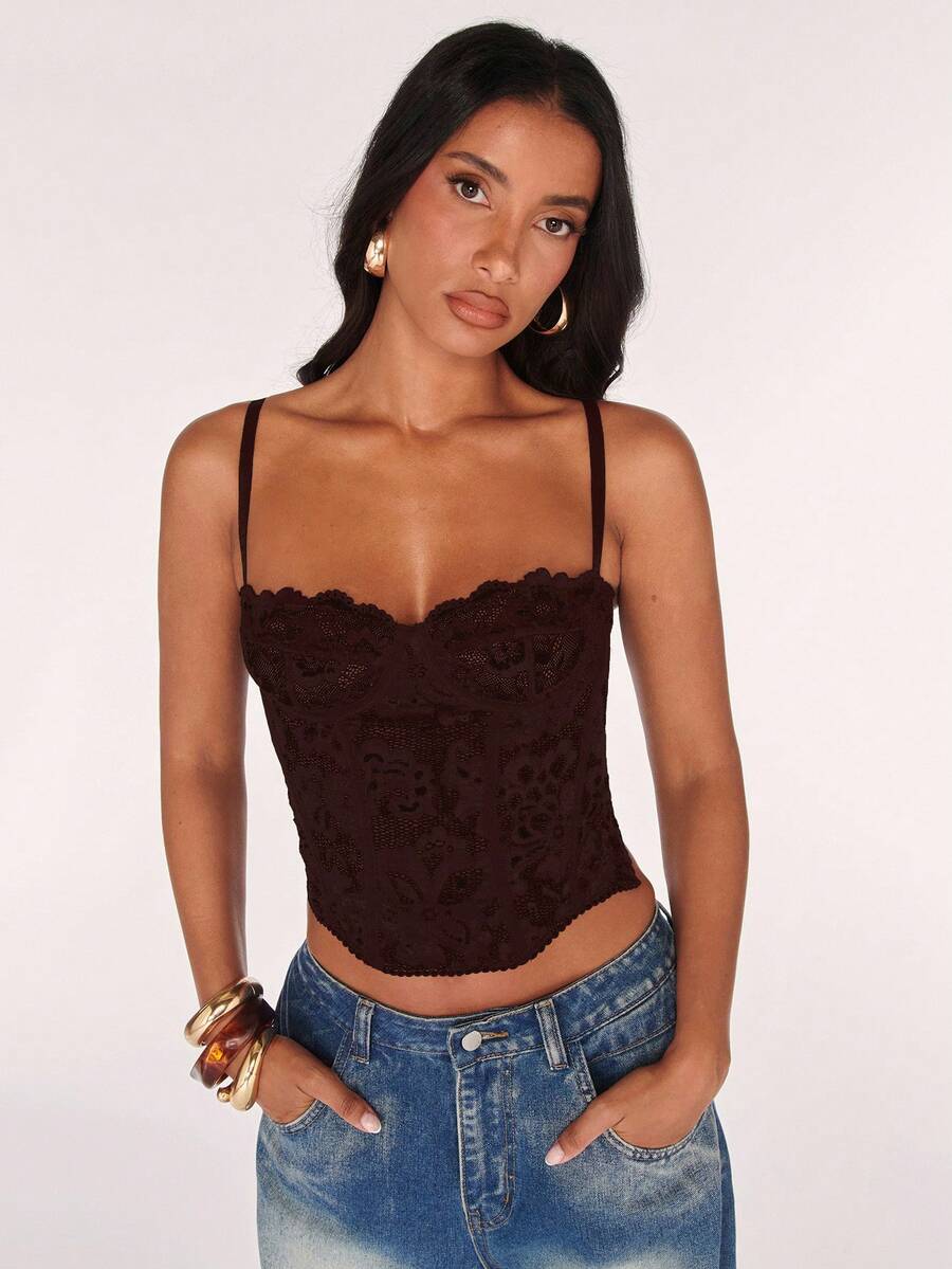 Black women’s lace cami top with spaghetti straps, contrast lace details, and an asymmetrical hem, styled as a slim-fit lined casual top.