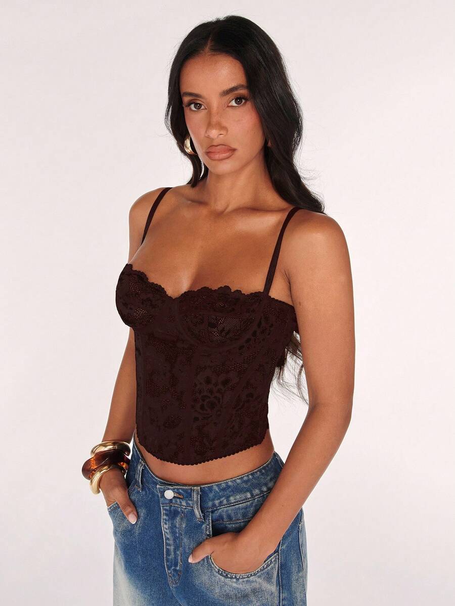 Black women’s lace cami top with spaghetti straps, contrast lace details, and an asymmetrical hem, styled as a slim-fit lined casual top.