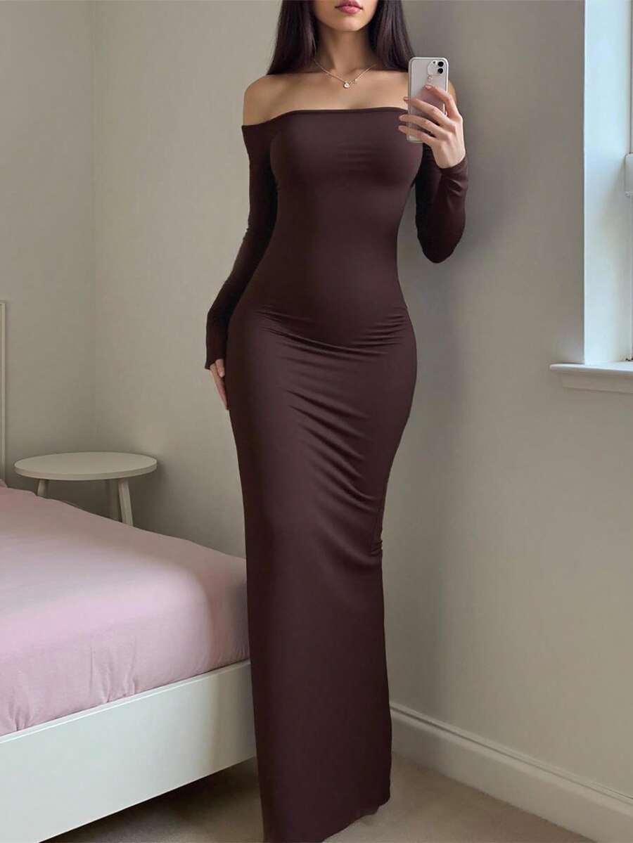Woman wearing an elegant off-the-shoulder bodycon long dress with backless design and pencil silhouette in high-stretch knitted fabric.