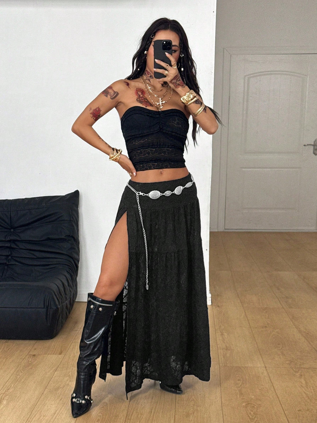Women's black low waist split thigh long skirt featuring semi-sheer textured fabric and a flared skinny fit.