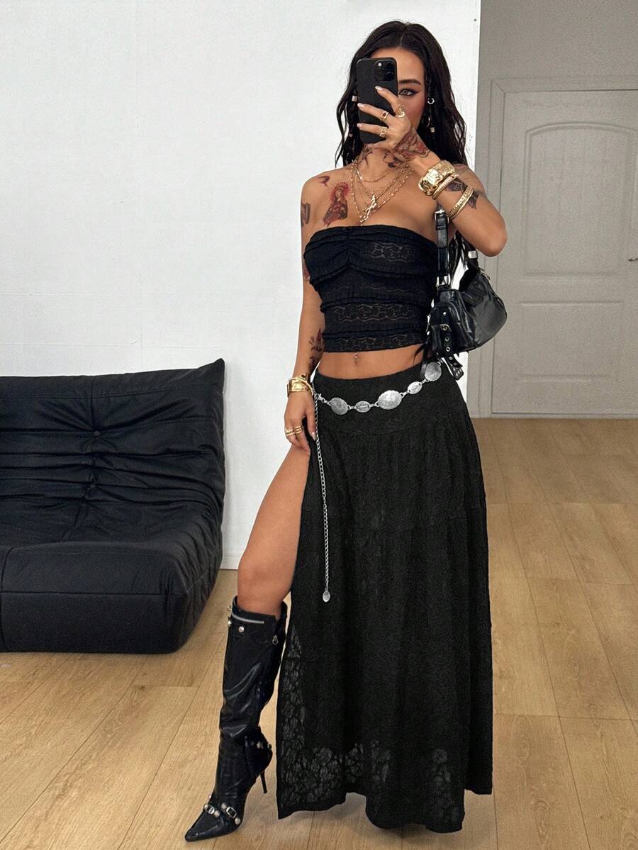 Women's black low waist split thigh long skirt featuring semi-sheer textured fabric and a flared skinny fit.