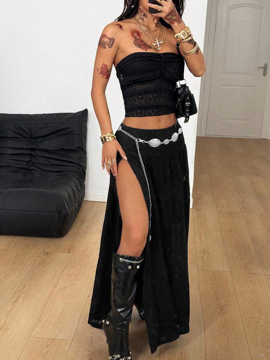 Women's black low waist split thigh long skirt featuring semi-sheer textured fabric and a flared skinny fit.