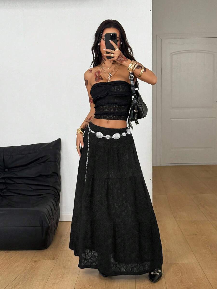 Women's black low waist split thigh long skirt featuring semi-sheer textured fabric and a flared skinny fit.