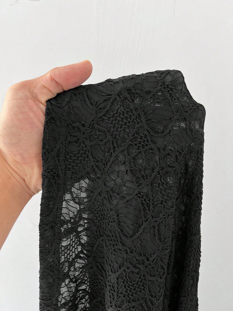 Women's black low waist split thigh long skirt featuring semi-sheer textured fabric and a flared skinny fit.