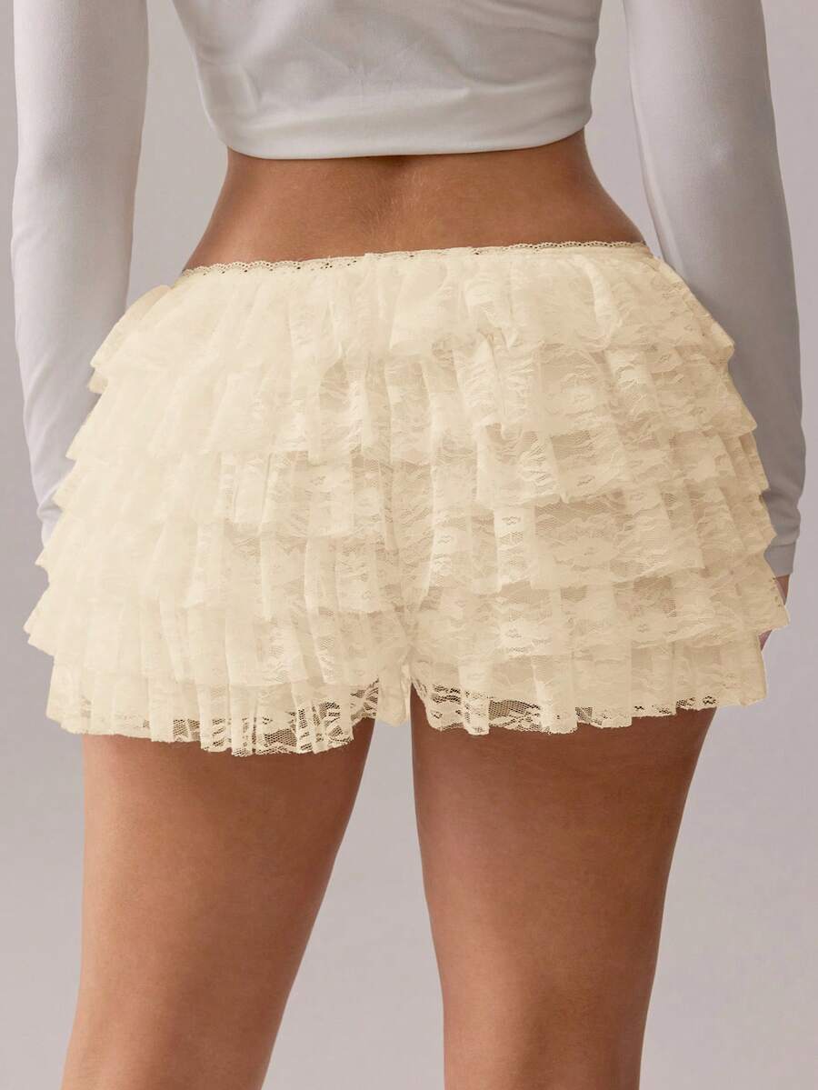 Apricot tiered lace ruffle hem low waist shorts for women featuring elastic waist and lined semi-sheer knit fabric.