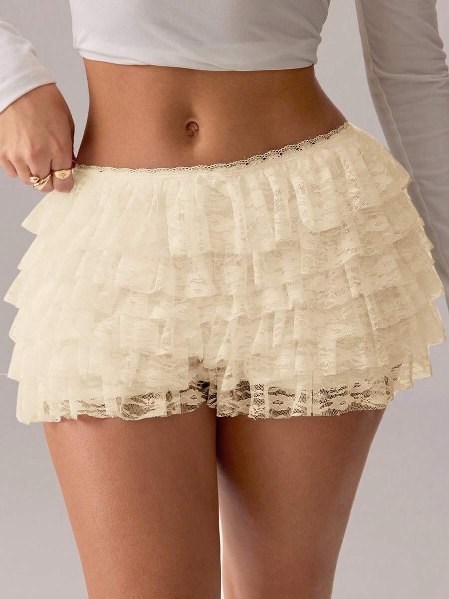 Apricot tiered lace ruffle hem low waist shorts for women featuring elastic waist and lined semi-sheer knit fabric.