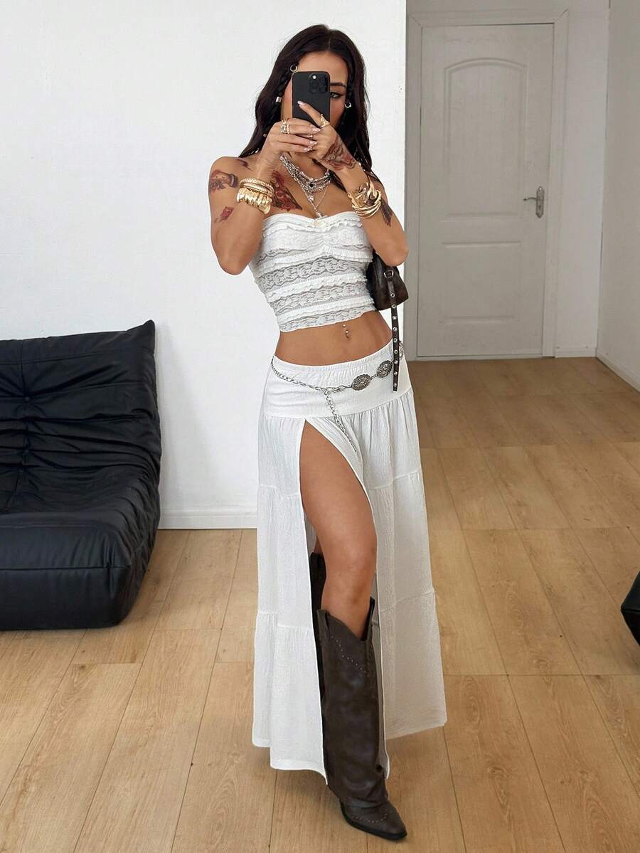 Women's black low waist split thigh long skirt featuring semi-sheer textured fabric and a flared skinny fit.