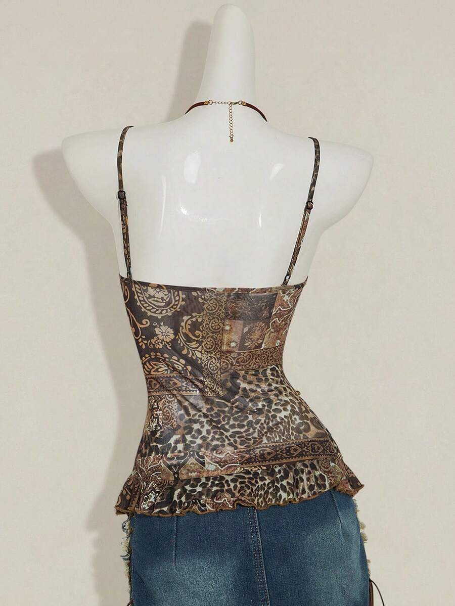 Women's burgundy floral graphic print mesh camisole top featuring an asymmetrical hem, backless cut, and spaghetti straps.