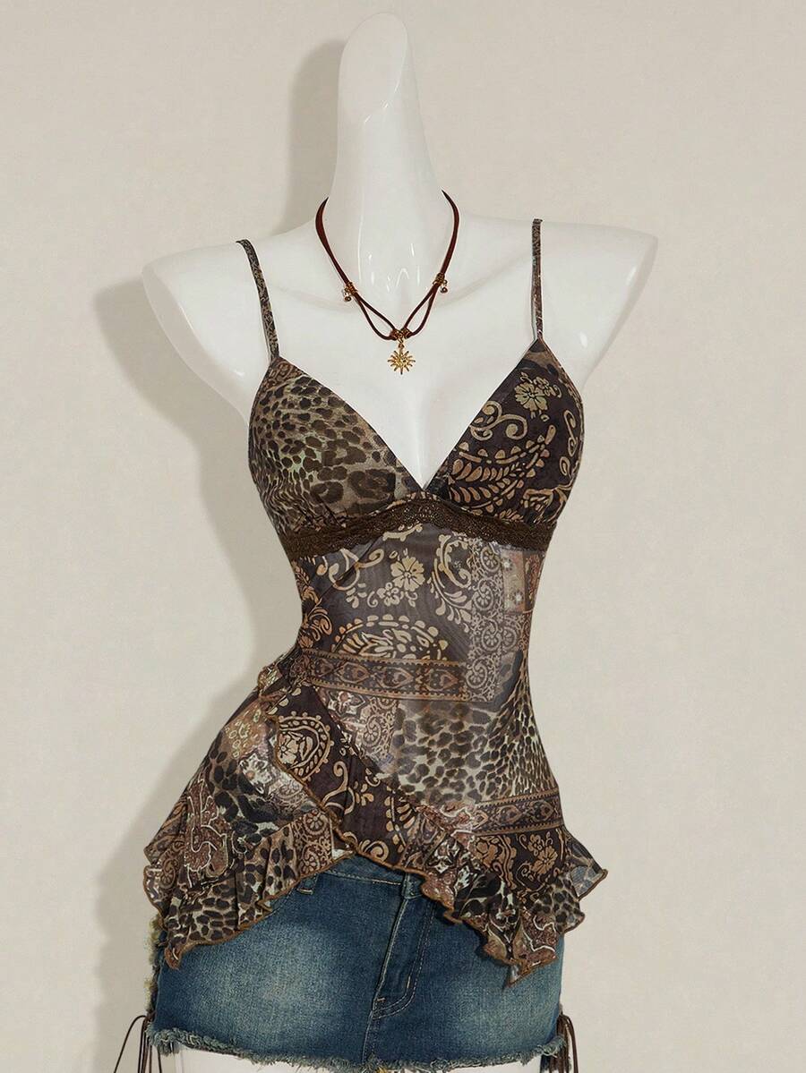 Women's burgundy floral graphic print mesh camisole top featuring an asymmetrical hem, backless cut, and spaghetti straps.