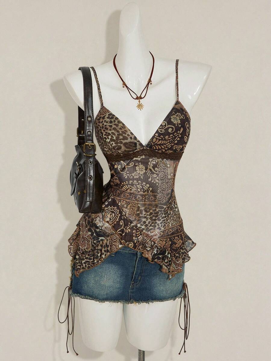 Women's burgundy floral graphic print mesh camisole top featuring an asymmetrical hem, backless cut, and spaghetti straps.
