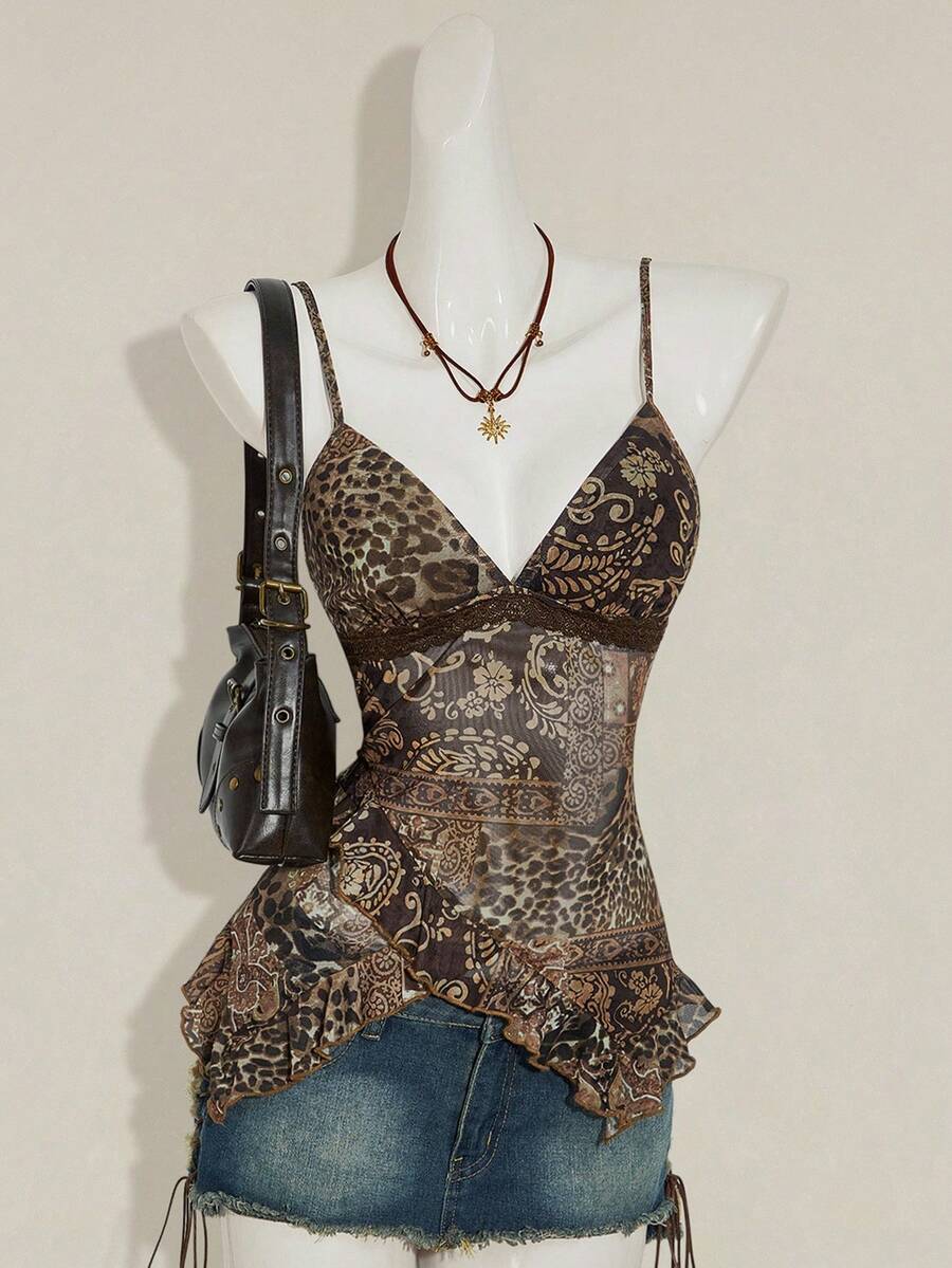 Women's burgundy floral graphic print mesh camisole top featuring an asymmetrical hem, backless cut, and spaghetti straps.