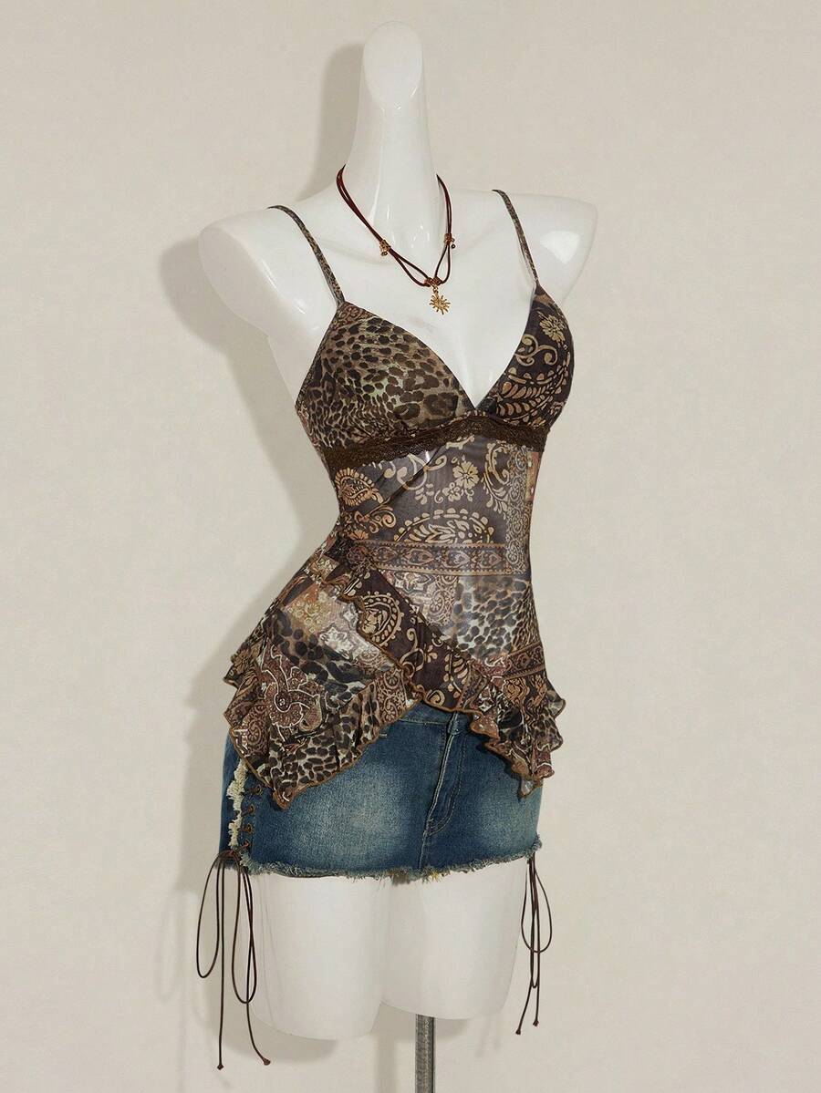 Women's burgundy floral graphic print mesh camisole top featuring an asymmetrical hem, backless cut, and spaghetti straps.