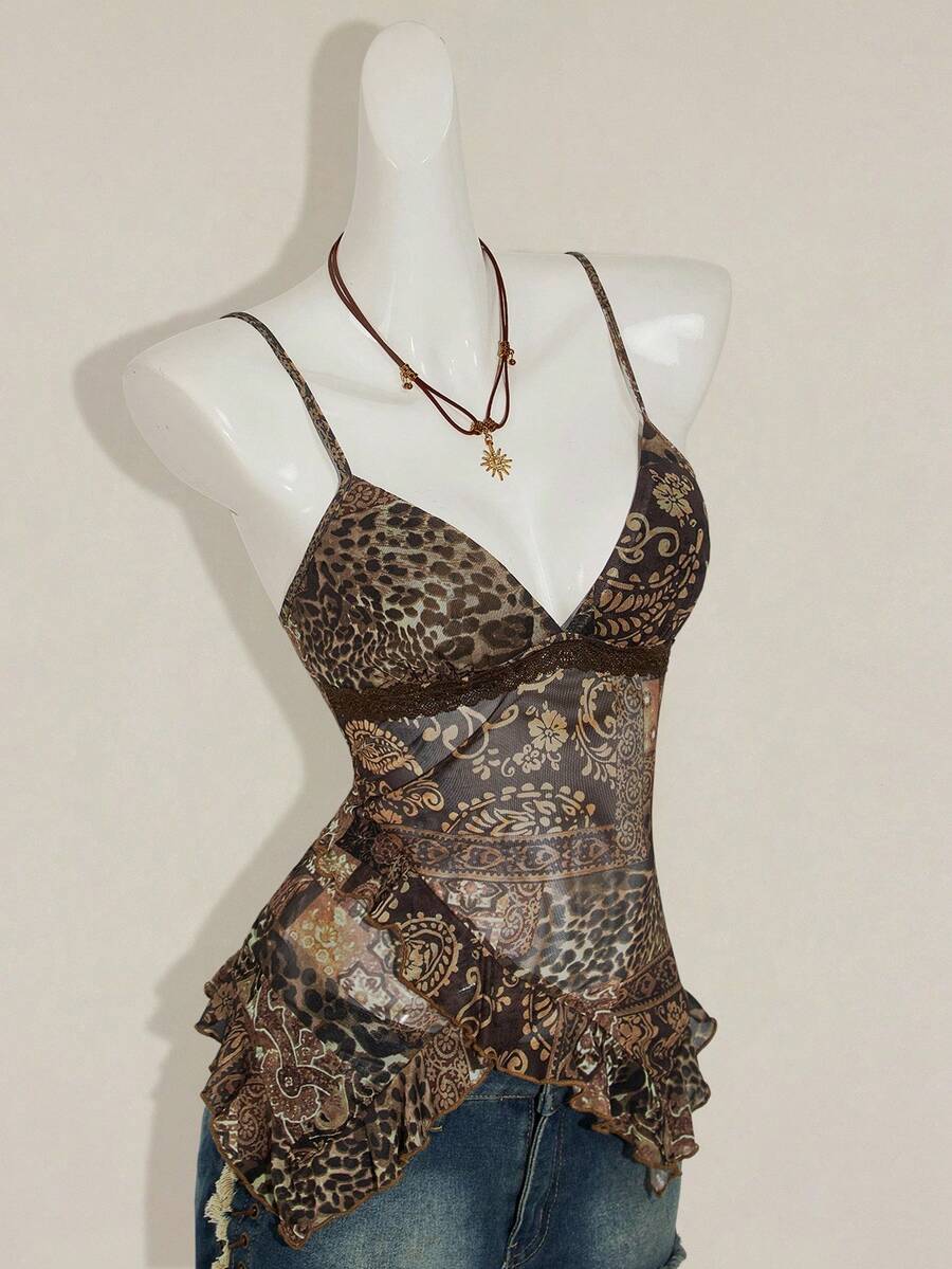 Women's burgundy floral graphic print mesh camisole top featuring an asymmetrical hem, backless cut, and spaghetti straps.