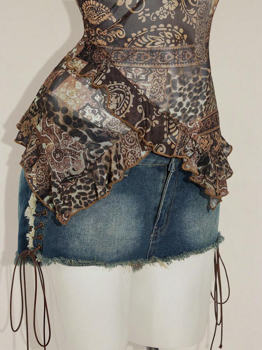 Women's burgundy floral graphic print mesh camisole top featuring an asymmetrical hem, backless cut, and spaghetti straps.