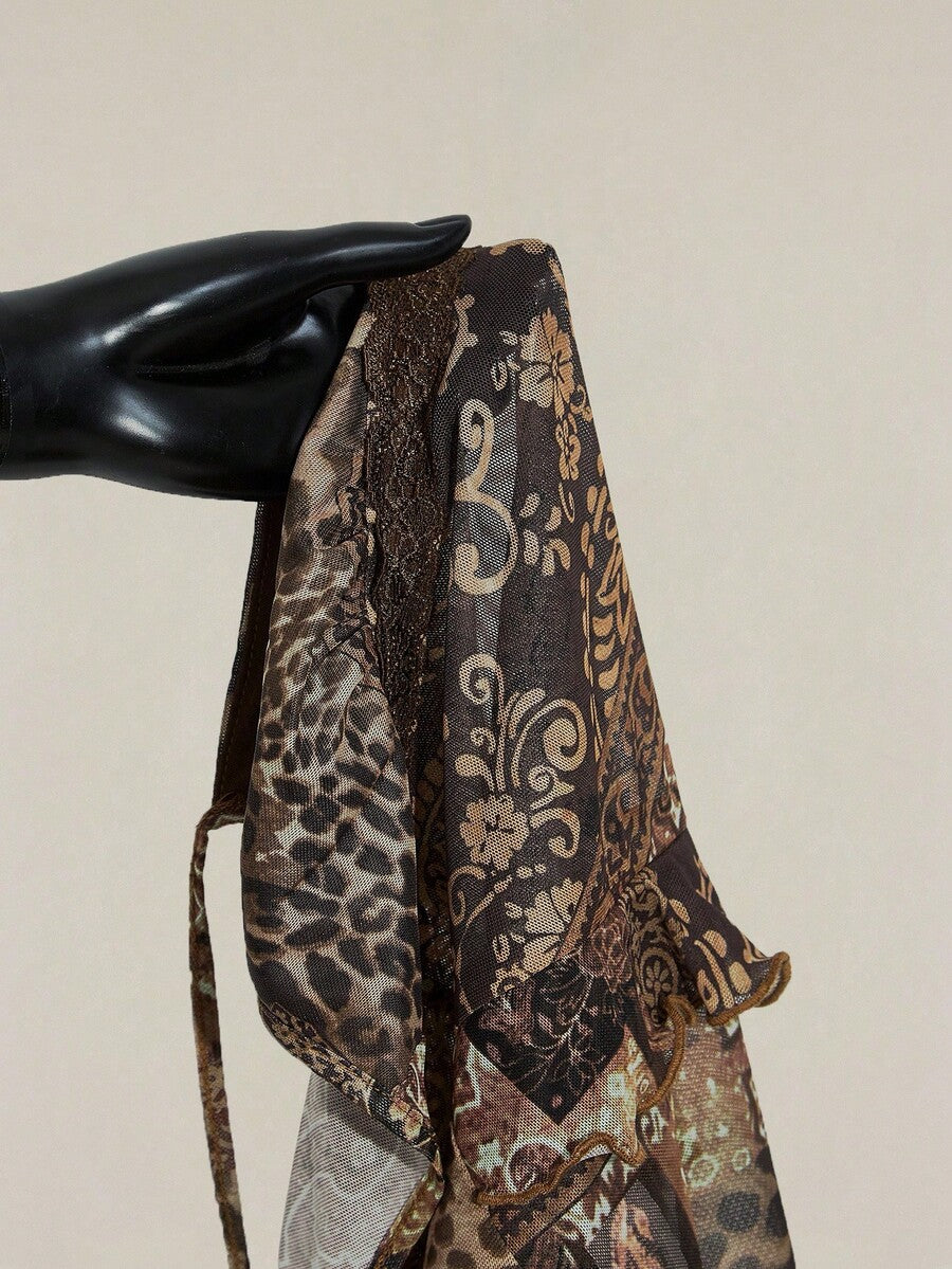 Women's burgundy floral graphic print mesh camisole top featuring an asymmetrical hem, backless cut, and spaghetti straps.