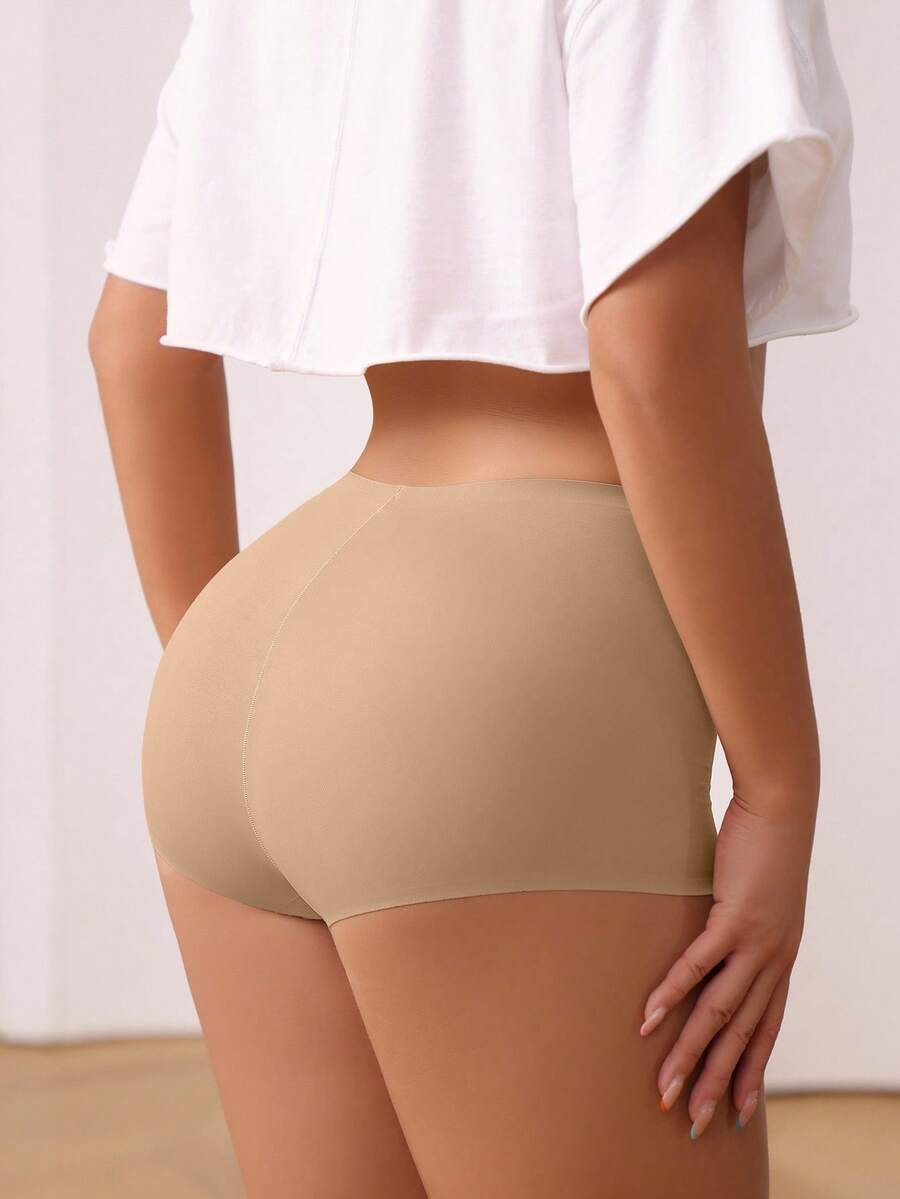 Women's black high stretch shapewear shorts with a mid waist fit and semi-sheer fabric.