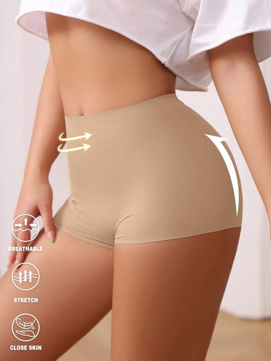 Women's black high stretch shapewear shorts with a mid waist fit and semi-sheer fabric.