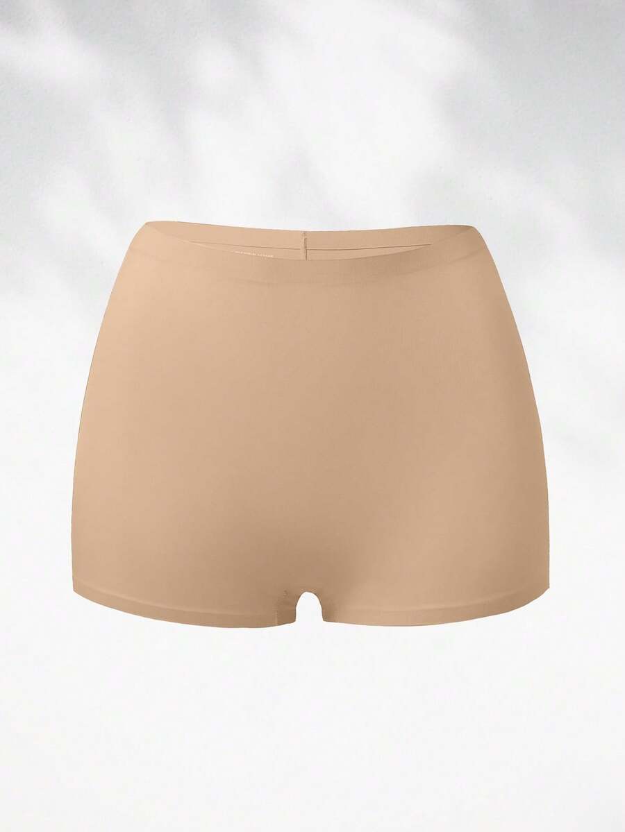 Women's black high stretch shapewear shorts with a mid waist fit and semi-sheer fabric.