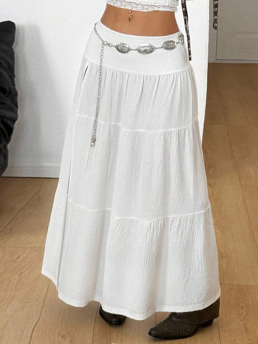 Women's black low waist split thigh long skirt featuring semi-sheer textured fabric and a flared skinny fit.